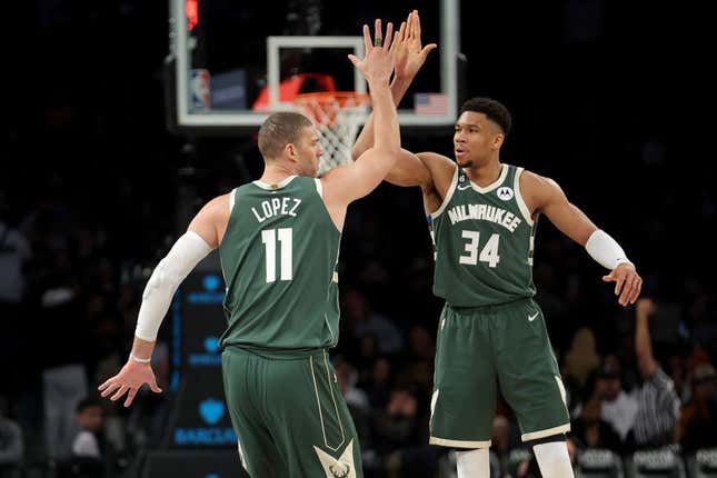 Feb 28, 2023; Brooklyn, New York, USA; Milwaukee Bucks center Brook Lopez (11) high fives forward Giannis Antetokounmpo (34) during the third quarter against the Brooklyn Nets at Barclays Center.