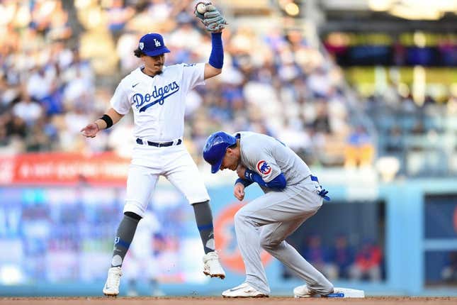 Apr 15, 2023; Los Angeles, California, USA; Chicago Cubs center fielder Cody Bellinger is safe at second base against Los Angeles Dodgers second baseman Miguel Vargas during the second inning at Dodger Stadium.