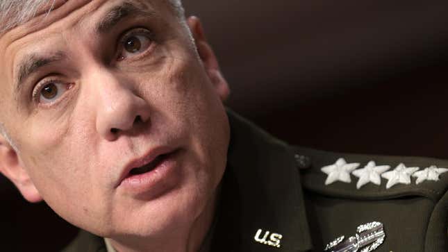Paul Nakasone stares past the viewer with his lips slightly open. His uniform lapel has U.S. on it and four stars on his shoulder.