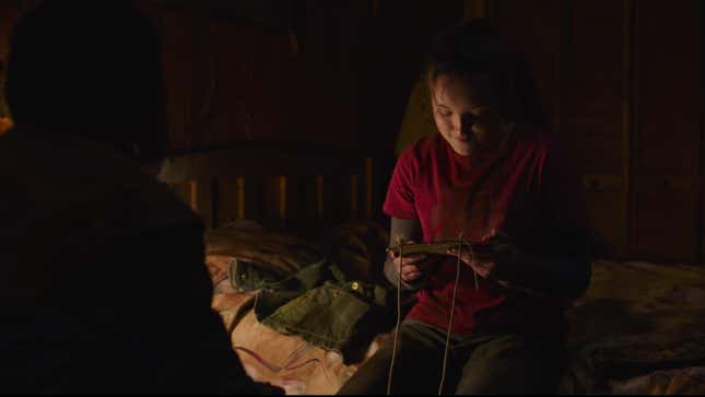 Ellie reads something Sam has written on his sketchpad in HBO's The Last of Us.