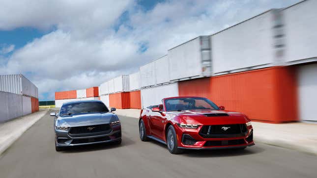 A photo of two 2024 Ford Mustangs driving round a track. 