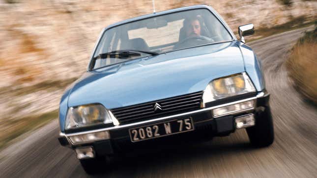 A photo of the front end on a light blue Citroen CX car. 