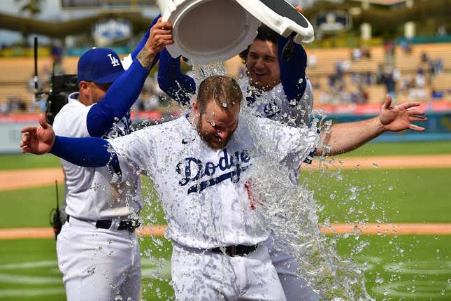May 3, 2023; Los Angeles, California, USA; Los Angeles Dodgers left fielder David Peralta (6) and center fielder James Outman (33) pour water on third baseman Max Muncy (13) after he his a walk off grand slam home run against the Philadelphia Phillies at Dodger Stadium.
