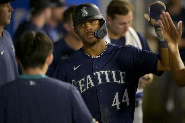 Aug 5, 2023; Anaheim, California, USA;  Seattle Mariners center fielder Julio Rodriguez (44) is congratulated in the dugout after scoring a run in the eighth inning against the Los Angeles Angels at Angel Stadium.