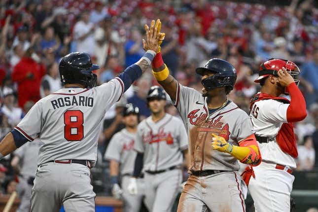 Apr 3, 2023; St. Louis, Missouri, USA;  Atlanta Braves right fielder Ronald Acuna Jr. (13) celebrates with left fielder Eddie Rosario (8) after hitting a three run home run against the St. Louis Cardinals during the second inning at Busch Stadium.