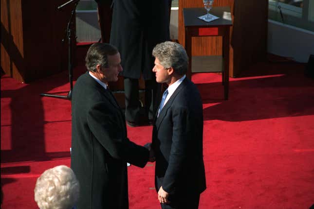 Passing the torch: Bill Clinton takes over from George Bush Senior.