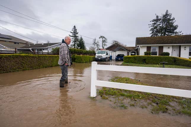 Corky Beall surveys floodwaters on College Road in Watsonville, California, Friday, March 10, 2023