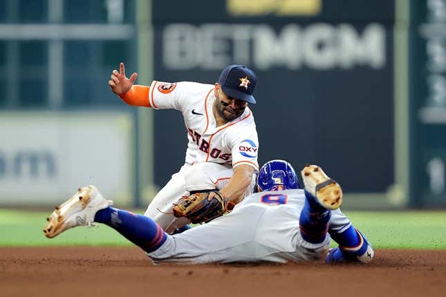 Jun 21, 2023; Houston, Texas, USA; Houston Astros second baseman Jose Altuve (27) tags out New York Mets center fielder Brandon Nimmo (9) after a base hit during the seventh inning at Minute Maid Park.