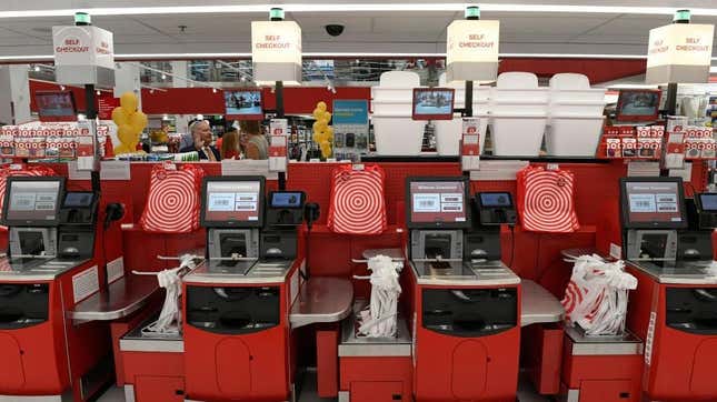 A line of Target self-checkout kiosks with no candy or snacks nearby