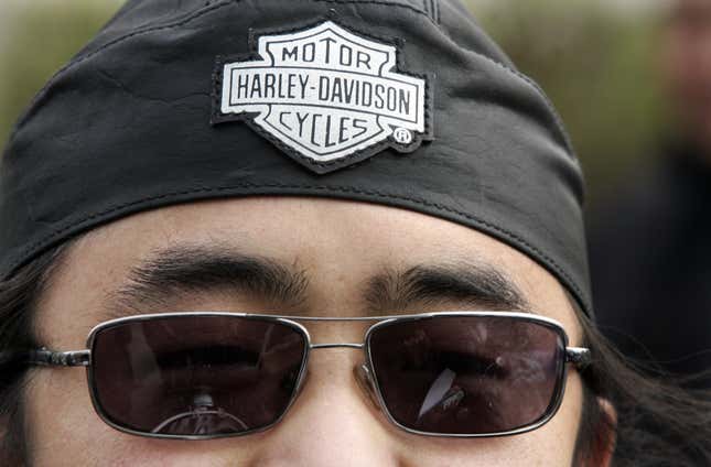 A Chinese motorcycle enthusiast wears a Harley-Davidson headband outside the newly-opened Harley-Davidson dealership in Beijing on April 8, 2006.