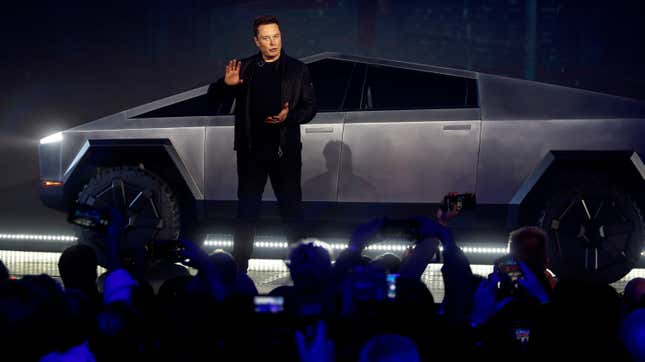 Elon Musk stands in front of the Tesla Cybertruck on stage in front of the audience at its unveiling