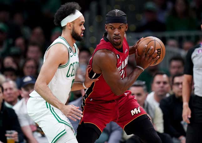 May 19, 2023; Boston, Massachusetts, USA; Miami Heat forward Jimmy Butler (22) looks to pass against Boston Celtics guard Derrick White (9) during the first half of game two of the Eastern Conference Finals for the 2023 NBA playoffs at TD Garden.