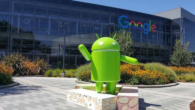 The Android mascot in front of a Google building. 