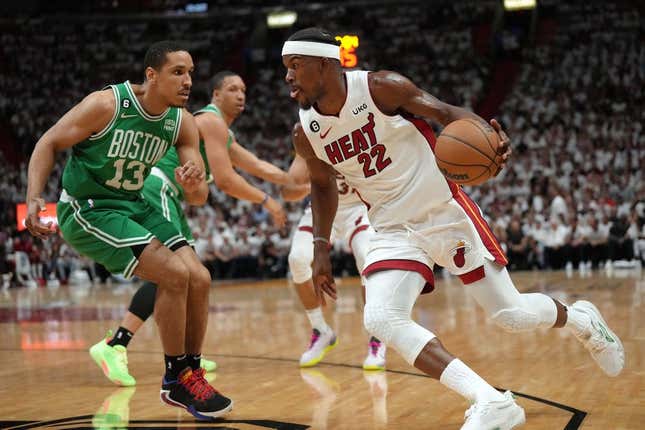 23 de mayo de 2023; Miami, Florida, Estados Unidos; El alero del Miami Heat, Jimmy Butler (22), controla el balón contra el escolta de los Boston Celtics, Malcolm Brogdon (13), en el primer cuarto durante el cuarto juego de las Finales de la Conferencia Este para los playoffs de la NBA de 2023 en el Kaseya Center.