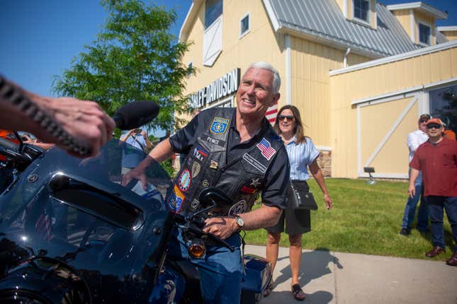 Former Vice President Mike Pence, center, gets on a motorcycle during the Roast and Ride hosted by Senator Joni Ernst in Des Moines, Iowa, US, on Saturday, June 3, 2023