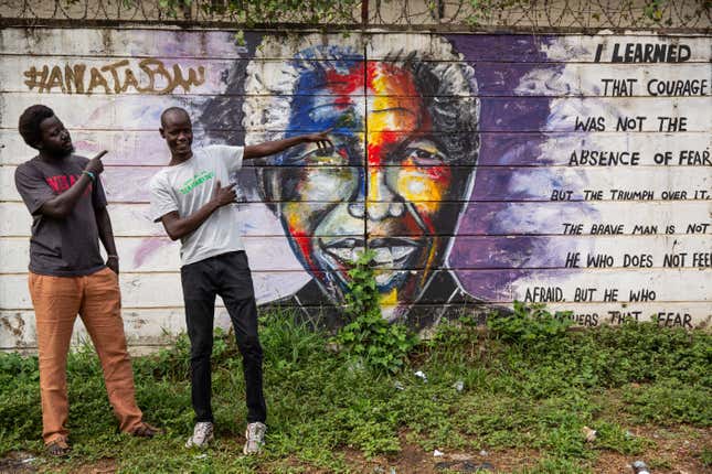 Jacob Bul and Tom Dai pose infront of a mural by Anataban