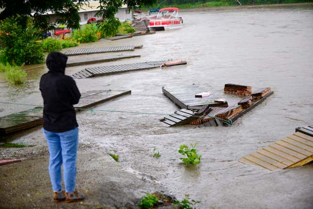 People look as as docks and boats are washed away on the West River in Brattleboro, Vt., near The Marina, Monday, July 10, 2023.
