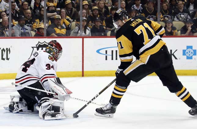 Apr 11, 2023; Pittsburgh, Pennsylvania, USA;  Chicago Blackhawks goaltender Petr Mrazek (34) defends Pittsburgh Penguins center Evgeni Malkin (71) during the second period at PPG Paints Arena. Chicago won 5-2.