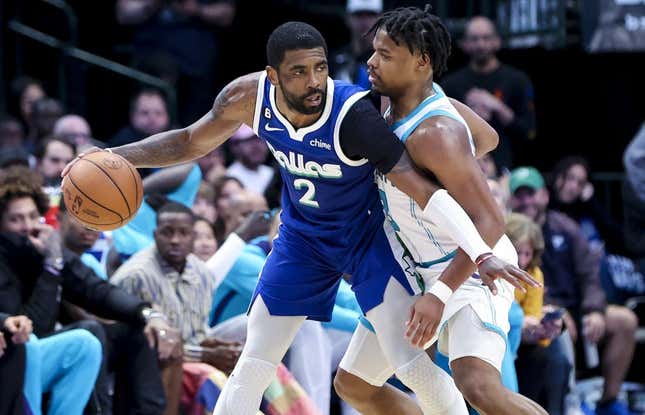 Mar 24, 2023; Dallas, Texas, USA;  Dallas Mavericks guard Kyrie Irving (2) controls the ball as Charlotte Hornets guard Dennis Smith Jr. (8) defends during the fourth quarter at American Airlines Center.