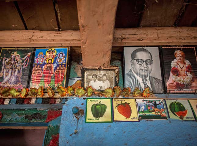 An old photo of Namdeo and Bagabai (C) hangs on a wall inside their house