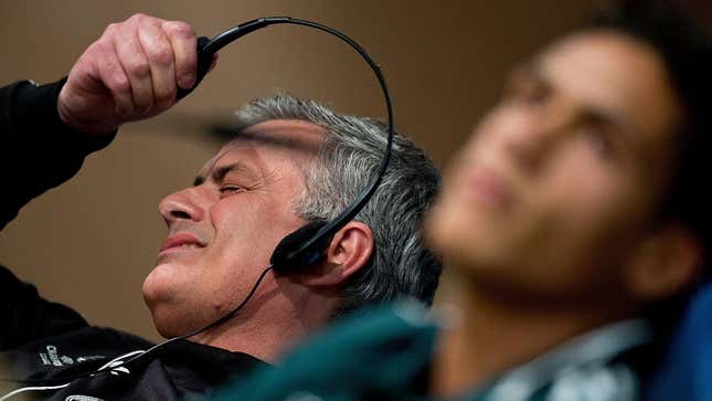 Former Premier League manager Jose Mourinho rips off his headphones in disgust. 