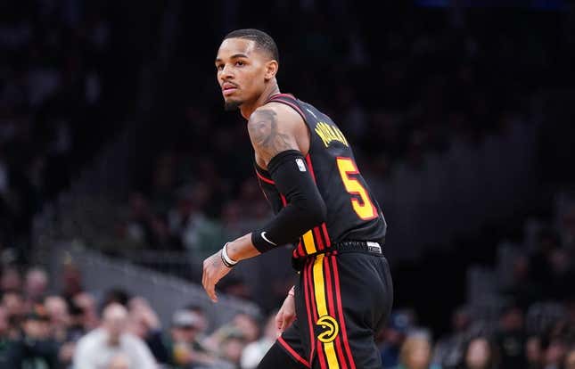 Apr 18, 2023; Boston, MA, USA; Atlanta Hawks guard Dejounte Murray (5) makes a field goal in the third quarter of Game 2 of the 2023 NBA Playoffs at TD Garden Looking back at the Boston Celtics bench after a 3-pointer.