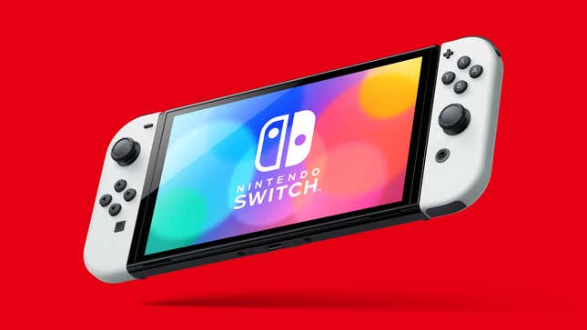 A Nintendo Switch OLED model is suspended in front of a red background. 