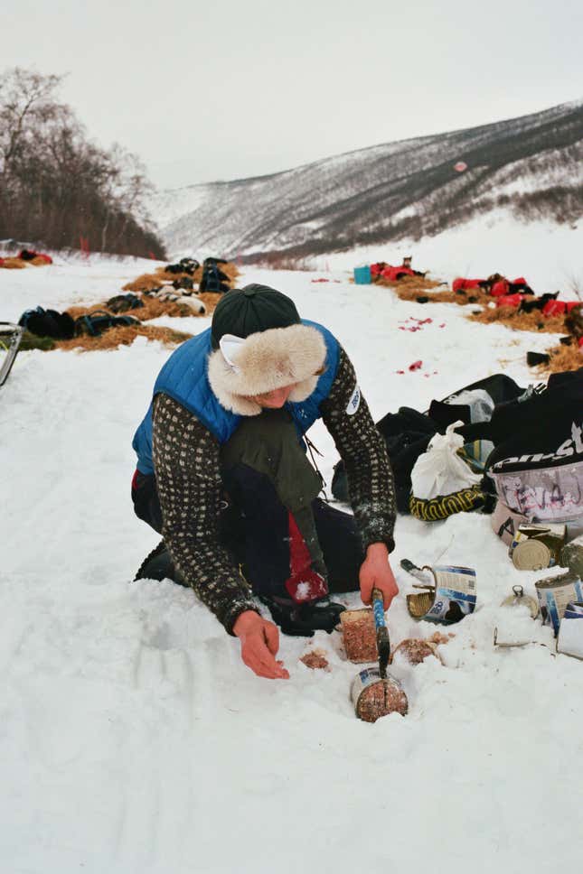 Arnt Ola Skjerve opens some meat cans for his dogs at a checkpoint.