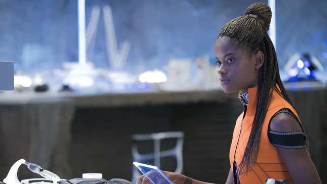 Letitia Wright's Princess Shuri looks up from a computer monitor in her tech lab in a scene from Black Panther.