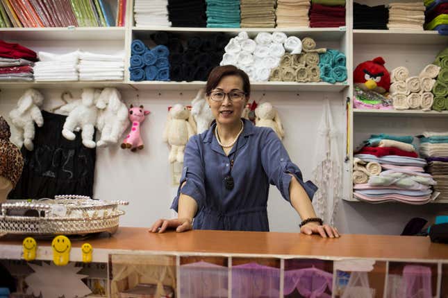 Zhu Jianying poses at her store “Forever Helen,” in China Mall, one of dozens Chinese-run shopping centers in Johannesburg.