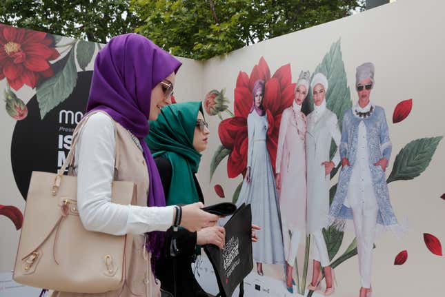 People arrive to attend a fashion show during the International Modest Fashion Week, in Istanbul, Friday, May 13, 2016. Turkeys first International Modest Fashion Week has opened in Istanbul bringing designers and models of conservative wear from around the world. The two-day event kicked off Friday with models hitting the runway at a historic train station donning a bright palette of breezy garment and kaleidoscopic headscarves. (AP Photo/Lefteris Pitarakis)