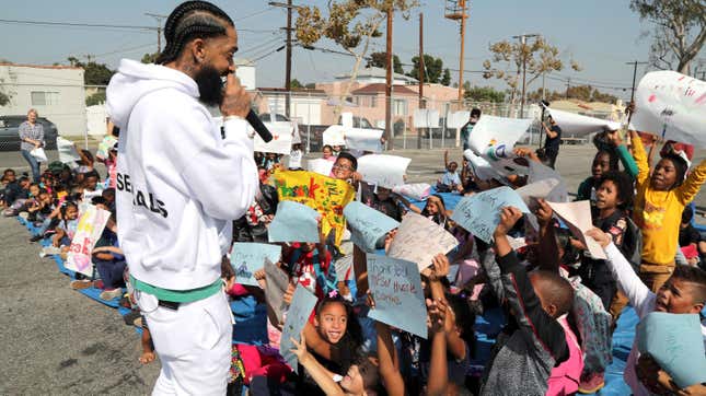 Nipsey Hussle speaks to kids at the Nipsey Hussle x PUMA Hoops Basketball Court Refurbishment Reveal Event in 2018