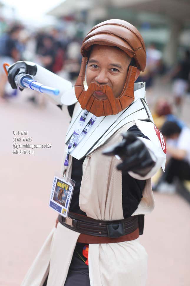 A cosplayer dressed as Obi-Wan Kenobi from The Clone Wars series, complete with hair and bread.