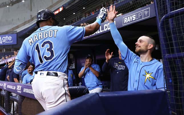Apr 8, 2023; St. Petersburg, Florida, USA; Tampa Bay Rays right fielder Manuel Margot (13) is congratulated by second baseman Brandon Lowe (8) after hitting a home run against the Oakland Athletics during the sixth inning at Tropicana Field.