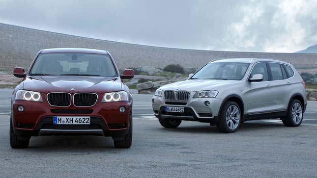 A photo of two BMW X3 SUVS parked in a parking lot. 