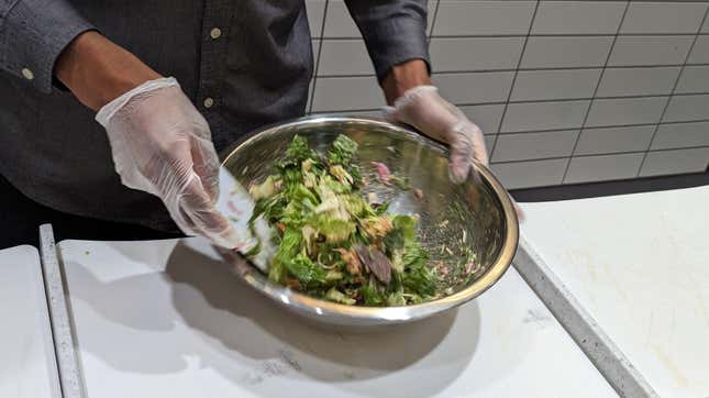 Chopt employee tossing a salad