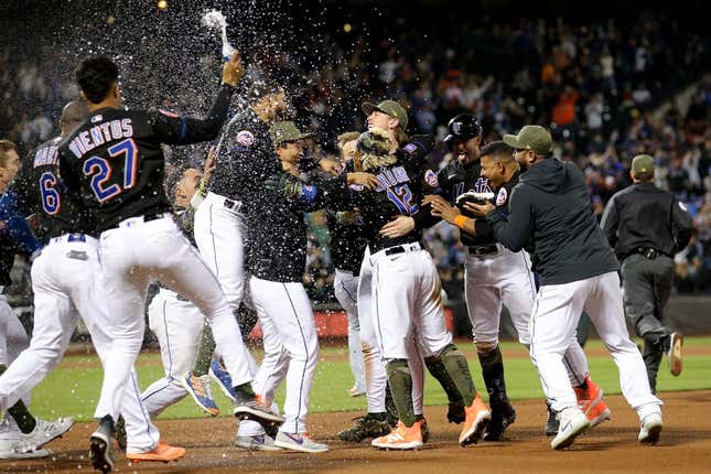May 19, 2023; New York City, New York, USA; New York Mets shortstop Francisco Lindor (12) celebrates his walkoff RBI single against the Cleveland Guardians with teammates at Citi Field.