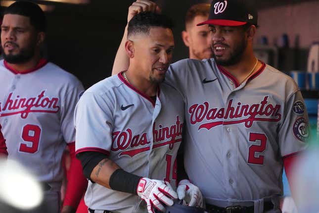 Apr 9, 2023; Denver, Colorado, USA; Washington Nationals second baseman Ildemaro Vargas (14) celebrates walking in a run with infielder Luis Garcia (2) in the sixth inning against the Colorado Rockies at Coors Field.