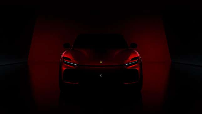 A very dark teaser image showing the high front end of the new Ferrari SUV. 