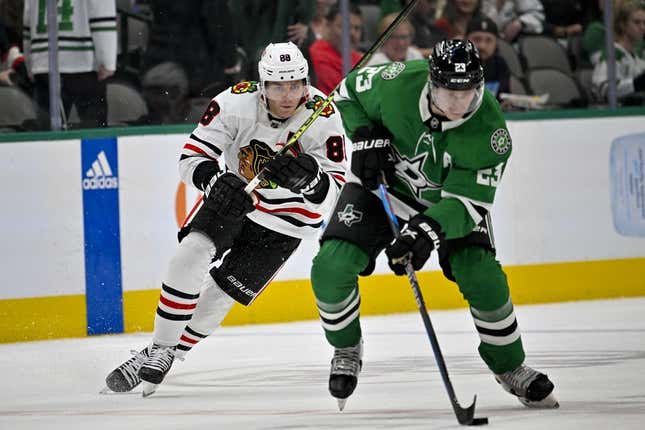 Feb 22, 2023; Dallas, Texas, USA; Chicago Blackhawks right wing Patrick Kane (88) and Dallas Stars defenseman Esa Lindell (23) chase the puck through center ice during the first period at the American Airlines Center.
