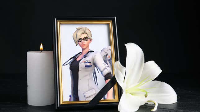 An image of Mercy in a picture frame appears next to a lit candle and a white flower.