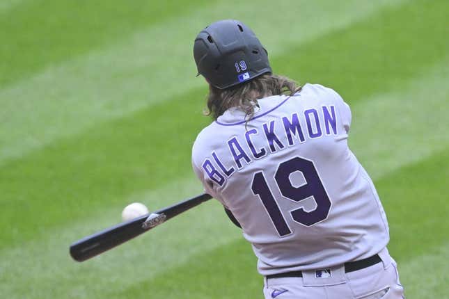 Apr 25, 2023; Cleveland, Ohio, USA; Colorado Rockies right fielder Charlie Blackmon (19) hits an RBI double during the second inning against the Cleveland Guardians at Progressive Field.
