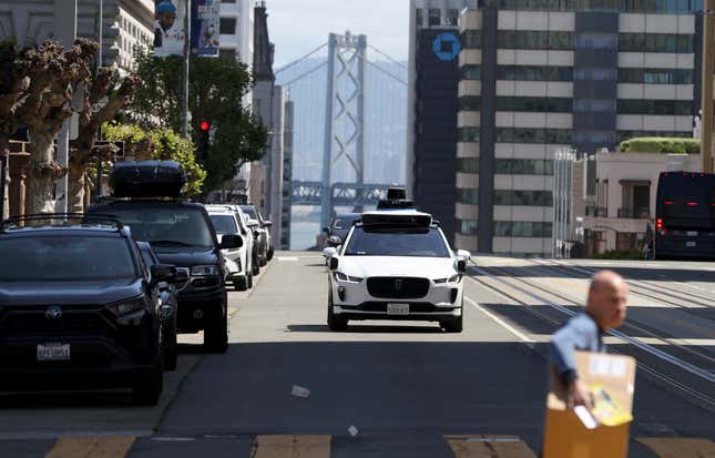 A Waymo autonomous vehicle drives along California Street on April 11, 2022 in San Francisco, California. 