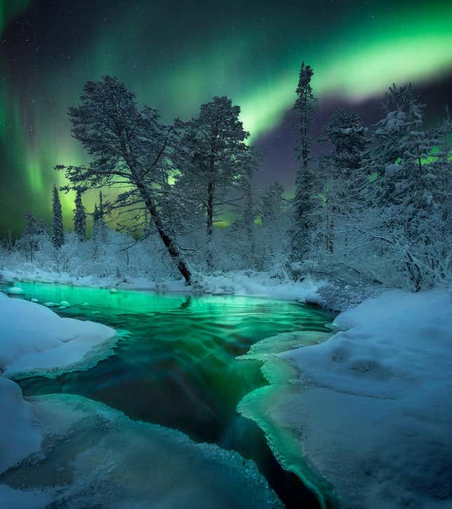 The Northern Lights over an icy river in Russia.