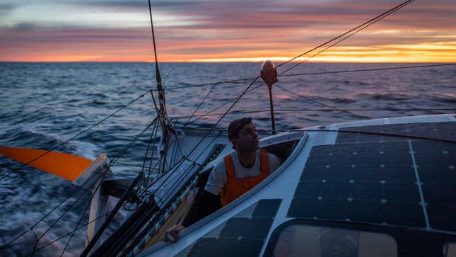 A photo of sunrise behind the stern of the 11th Hour Racing ship. 