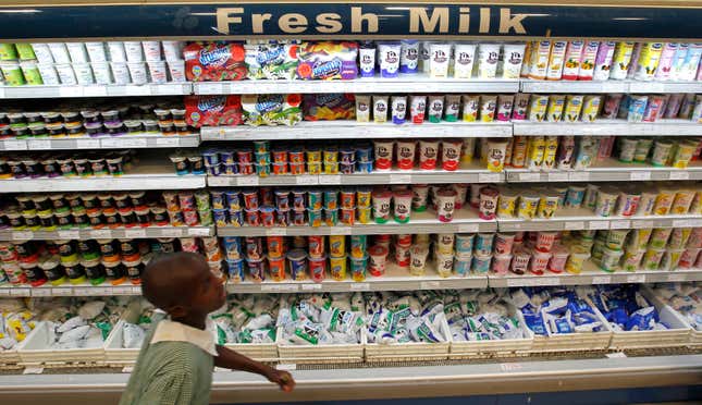 A girl in school uniform walks past Brookside dairy milk products displayed on a shelf inside the Nakumatt Lifestyle supermarket in Kenya's capital Nairobi, July 18, 2014. French food group Danone said it was buying a 40 percent stake in Brookside, East Africa's top dairy producer, as part of plans to expand in new markets while growth is weak in Europe and the economy slows in China. The deal, whose financial terms were not disclosed, was sealed with the controlling Kenyatta family, relatives of Kenya President Uhuru Kenyatta, and will boost Danone's earnings, Emmanuel Marchant, vice-president for corporate development, told Reuters by phone on Friday.