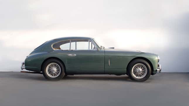 A side profile image of a green Aston Martin sports car. 