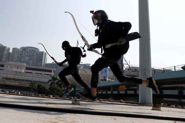 Protesters raced with bows as they practice running away from riot police.