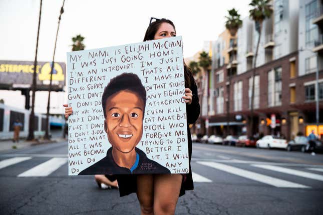 A person holds a sign at a candlelight vigil to demand justice for Elijah McClain on the one year anniversary of his death on August 24, 2020 in West Hollywood, California.