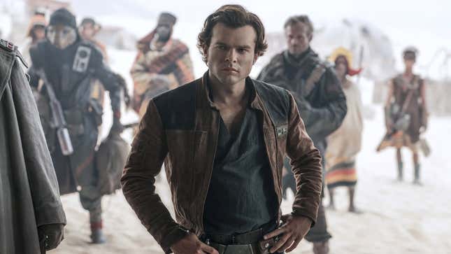 A young Han Solo stands in front of a group of people and aliens. 